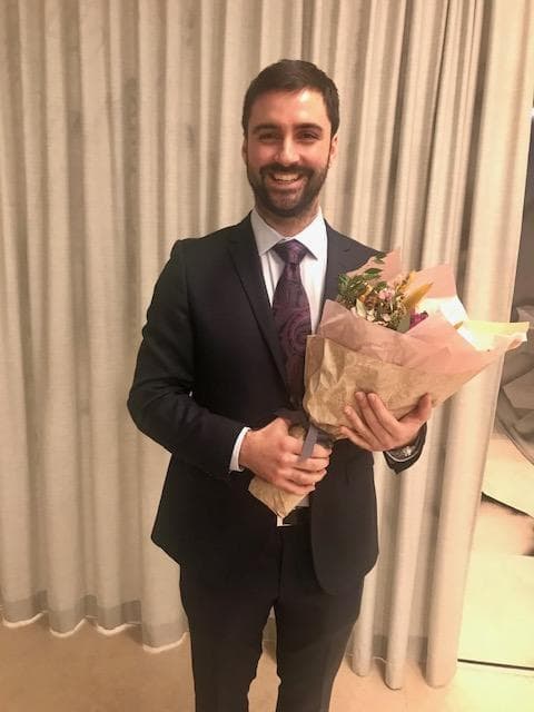 Alessio Buccino holding flowers